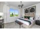 Spacious bedroom with a large window, plush bedding, and stylish decor at 8319 Sw 54Th Loop, Ocala, FL 34481