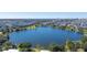 Aerial view of a lakefront community with lush green spaces at 9406 Dugard Ct, Orlando, FL 32827
