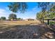 Expansive backyard with mature trees and a wooden fence at 4995 County Road 121D, Wildwood, FL 34785