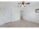 Bright bedroom with laminate flooring, ceiling fan, and white trim at 4995 County Road 121D, Wildwood, FL 34785