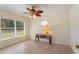 Bedroom featuring a decorative ceiling fan, accent window and hardwood floors at 4995 County Road 121D, Wildwood, FL 34785