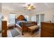 Bedroom featuring a decorative ceiling fan and hardwood floors at 4995 County Road 121D, Wildwood, FL 34785