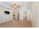 Bright bedroom featuring a decorative ceiling fan and hardwood floors at 4995 County Road 121D, Wildwood, FL 34785