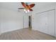 Bedroom with laminate flooring, ceiling fan, double closets and white trim at 4995 County Road 121D, Wildwood, FL 34785