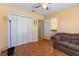 Bedroom featuring a large closet, a ceiling fan, and tile flooring at 4995 County Road 121D, Wildwood, FL 34785