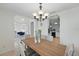 Bright dining room featuring modern lighting, a wooden table with seating for six, and views into the living spaces at 4995 County Road 121D, Wildwood, FL 34785