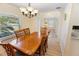 Dining room with chandelier lighting, wood table and views of the entrance at 4995 County Road 121D, Wildwood, FL 34785