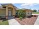 Inviting entryway with lush landscaping, stone accents, and a decorative front door at 4995 County Road 121D, Wildwood, FL 34785