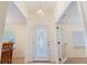 Foyer with chandelier, decorative glass door, and views to other rooms at 4995 County Road 121D, Wildwood, FL 34785