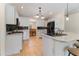 Bright kitchen featuring white cabinetry, stainless appliances and granite counters at 4995 County Road 121D, Wildwood, FL 34785