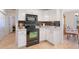 Kitchen area showcases stainless steel appliances and sleek black backsplash at 4995 County Road 121D, Wildwood, FL 34785