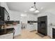 Well-lit kitchen with modern appliances, white cabinetry, and stylish backsplash at 4995 County Road 121D, Wildwood, FL 34785