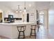 Modern kitchen boasts white cabinets, black appliances, and a breakfast bar at 4995 County Road 121D, Wildwood, FL 34785
