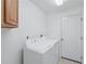 Laundry room featuring a white washer and dryer, and neutral walls at 4995 County Road 121D, Wildwood, FL 34785