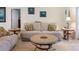 Cozy living room features neutral tones, tile flooring, and comfortable seating arrangements at 4995 County Road 121D, Wildwood, FL 34785