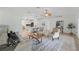 Spacious living room featuring a stylish rug, comfortable seating, and an open view to the kitchen at 4995 County Road 121D, Wildwood, FL 34785