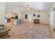 Open-concept living room showcasing natural light, stylish furnishings, and sleek tile flooring at 4995 County Road 121D, Wildwood, FL 34785