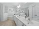 Elegant main bathroom with a double vanity, soaking tub, and a clean, modern design at 4995 County Road 121D, Wildwood, FL 34785
