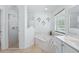 Inviting main bathroom featuring a glass-enclosed shower, soaking tub, and ample natural light at 4995 County Road 121D, Wildwood, FL 34785