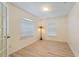 Bright office features neutral walls, light wood-look floors, and plenty of natural light from two windows at 4995 County Road 121D, Wildwood, FL 34785