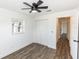 Spacious bedroom featuring wood-look floors and ample closet space at 1309 Buccaneer Ave, Deltona, FL 32725