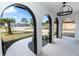 Elegant entryway with arched doorways, tile flooring, and a black chandelier at 1309 Buccaneer Ave, Deltona, FL 32725