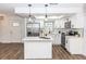 White kitchen with center island and stainless steel appliances at 1309 Buccaneer Ave, Deltona, FL 32725