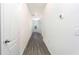 White hallway with grey wood-look floors and doors at 13454 Leaping Water Way, Astatula, FL 34705