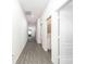 Bright hallway with wood-look floors and access to other rooms at 13481 Leaping Water Way, Astatula, FL 34705