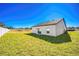 View of a single-story house, showcasing its back and side, with a grassy lawn at 13481 Leaping Water Way, Astatula, FL 34705