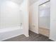 Bathroom featuring white subway tile, a tub and shower combo, and doorway at 13489 Leaping Water Way, Astatula, FL 34705