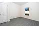 Cozy bedroom with a window and gray wood-look flooring at 13489 Leaping Water Way, Astatula, FL 34705