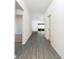 Hallway with gray wood-look flooring connecting the living spaces at 13489 Leaping Water Way, Astatula, FL 34705