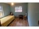 Small bedroom with a twin bed, small table and chair, and light blue walls at 2468 Fawn Run, Oviedo, FL 32765