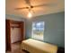 Bedroom with light yellow bedspread and wood-look flooring at 2468 Fawn Run, Oviedo, FL 32765