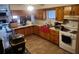 Cozy kitchen with wood cabinets and tile flooring at 2468 Fawn Run, Oviedo, FL 32765