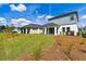 Expansive backyard featuring lush green grass, mulch beds, and a covered patio for outdoor enjoyment at 6074 Sacred Oak Ave, Mount Dora, FL 32757