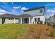 Beautiful backyard featuring a well-manicured lawn, mulch beds, and a covered patio for outdoor enjoyment at 6074 Sacred Oak Ave, Mount Dora, FL 32757