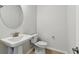 Powder room featuring a white sink and modern finishes at 6074 Sacred Oak Ave, Mount Dora, FL 32757