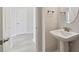 Bathroom featuring a pedestal sink and modern faucet fixtures at 6074 Sacred Oak Ave, Mount Dora, FL 32757