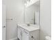 Bathroom featuring a double sink vanity with modern lighting and a large mirror at 6074 Sacred Oak Ave, Mount Dora, FL 32757