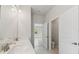 Bright bathroom featuring a double vanity, view to bedroom and separate toilet room at 6074 Sacred Oak Ave, Mount Dora, FL 32757