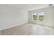 Bright bedroom with two windows offering natural light and outdoor views at 6074 Sacred Oak Ave, Mount Dora, FL 32757