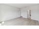 Bright bedroom featuring neutral paint, light wood flooring, and two entryways at 6074 Sacred Oak Ave, Mount Dora, FL 32757