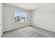 Bedroom featuring a large window with views of the neighborhood and soft gray carpeting at 6074 Sacred Oak Ave, Mount Dora, FL 32757
