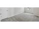 Bedroom featuring gray carpet and white trim at 6074 Sacred Oak Ave, Mount Dora, FL 32757