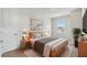 Comfortable bedroom with a minimalist design and a warm, inviting ambiance at 6074 Sacred Oak Ave, Mount Dora, FL 32757