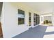 Covered patio showing expansive windows and backyard views, ideal for outdoor relaxation and entertainment at 6074 Sacred Oak Ave, Mount Dora, FL 32757