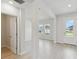 Entryway featuring neutral walls, light wood-style floors and a view of the outdoors through the front door at 6074 Sacred Oak Ave, Mount Dora, FL 32757