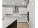 Well-lit kitchen featuring white cabinets, stainless steel appliances, and a spacious countertop at 6074 Sacred Oak Ave, Mount Dora, FL 32757